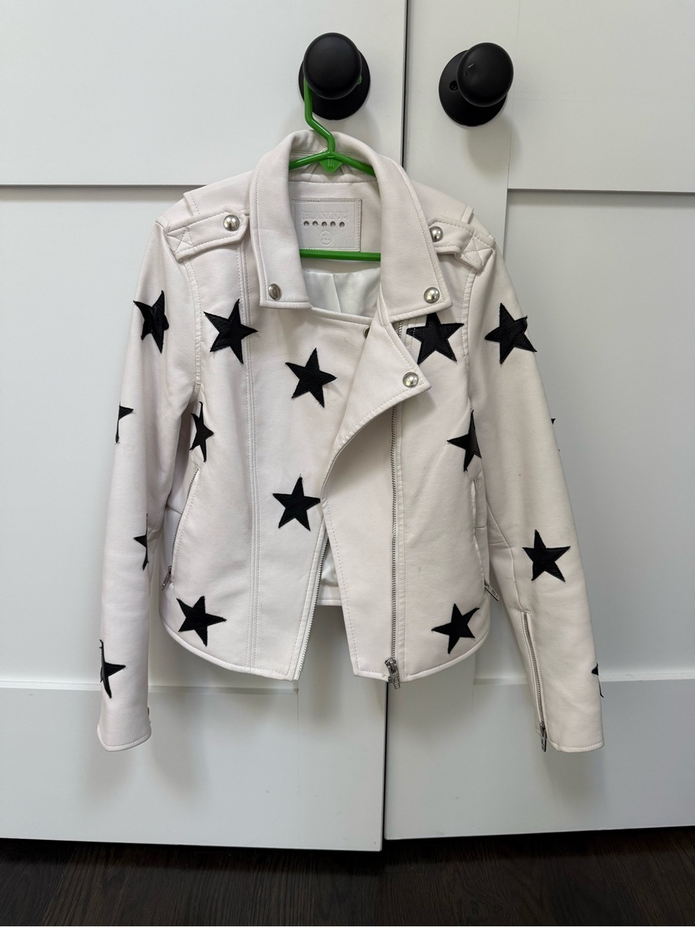Blank NYC White Faux Leather Moto Jacket with Black Stars